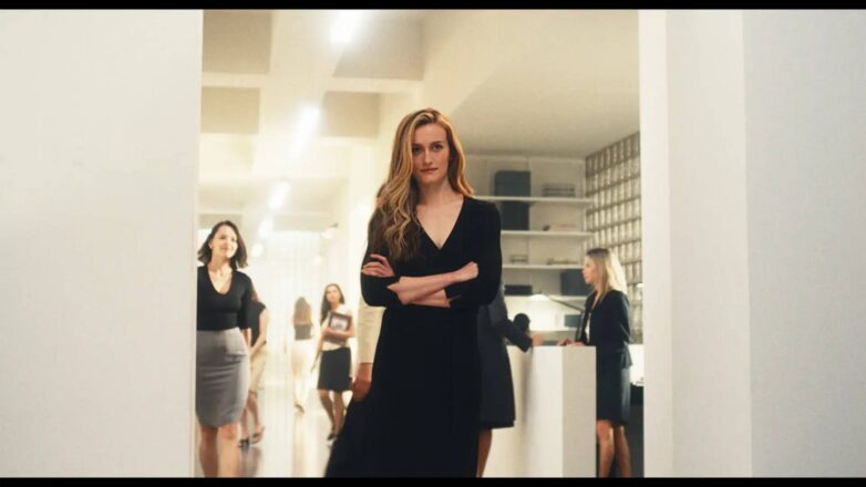 Svetao minimalistički kancelarijski prostor sa staklenom opekom i belim policama u seriji Love Story, inspirisan estetikom devedesetih