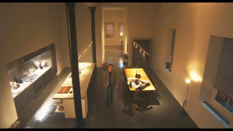 Prostrani njujorški loft sa visokim plafonima, crnim podom, minimalističkom kuhinjom i dugim drvenim trpezarijskim stolom u seriji Love Story