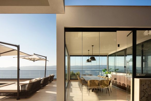 Trpezarija u vili Mirabel sa velikim staklenim zidovima i pogledom na more